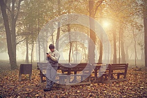 Man play in his mobile phone in the park