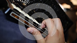 Man playing the accordion black wedding detail. Close up cinematic wedding save the date clip.