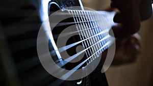 Man playing acoustic guitar at home, hand close-up. Concept. Close-up of a man playing a guitar