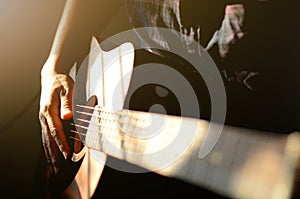 Man playing on acoustic guitar, a pleasant, relaxing day, music and sound, Closeup