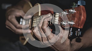 Man playing acoustic ukulele