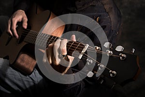Man playing acoustics guitar