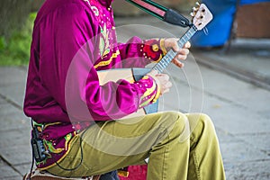 Man playing balalaika.