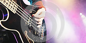 Man Playing Bass Guitar At Concert photo