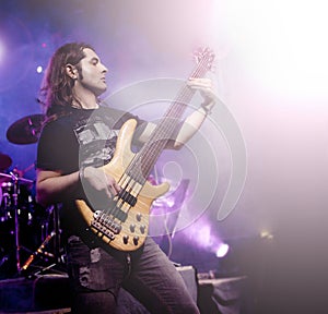 Man playing bass guitar in live concert sequence. Live music background