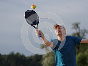 Man playing beach tennis