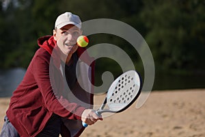 Man playing beach tennis