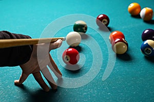 Man playing billiard at green table, closeup