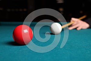 Man playing billiard at green table, closeup. Space for text