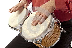 Man playing bongo set on his lap