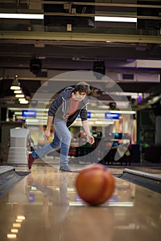 Man playing bowling game. Focus is on man