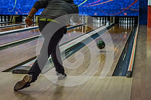 Man playing bowling seen from the back