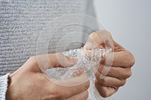 Man playing with bubble wrap