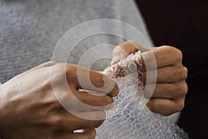 Man playing with bubble wrap