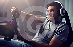 Man playing car racing video game at home