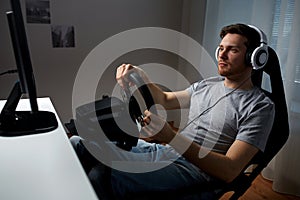 Man playing car racing video game at home