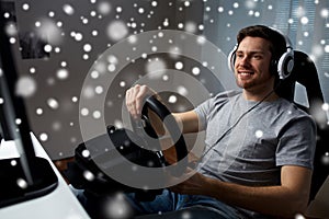 Man playing car racing video game at home