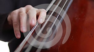 Man playing the cello finger closeup.