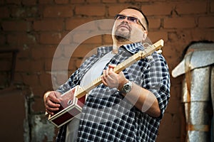 Man playing cigar box guitar