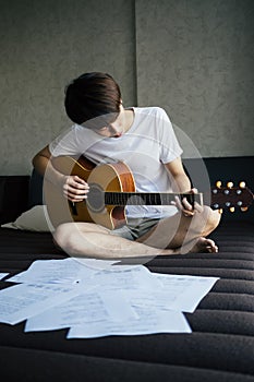 Man playing classical guitar in the room