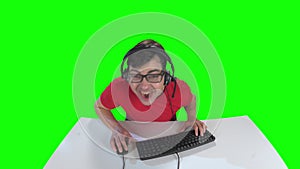 Man playing computer game sitting home at the table