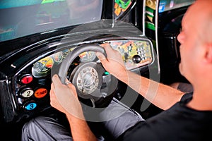 Man playing driving wheel video game