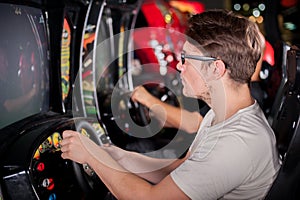 Man playing driving wheel video game