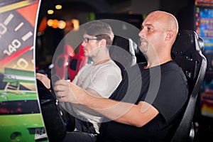 Man playing driving wheel video game