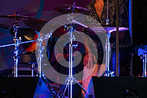 Man playing drums on stage of ethnic open air concert