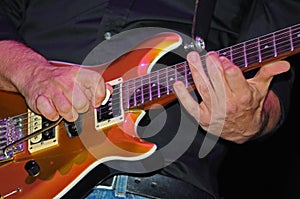 Man playing the electric guitar photo