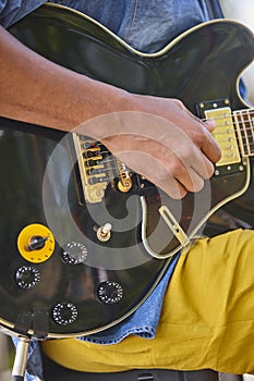 Man playing electric guitar detail. Musician on the street