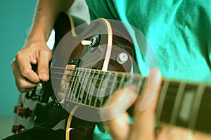 Man playing on electric guitar, a pleasant, relaxing day, music and sound, Closeup