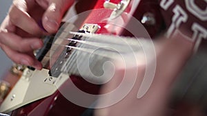 Man playing electric guitar using tremolo technique