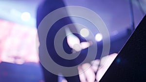 Man playing on electric piano under strobe lights on the stage