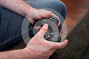 Man playing, focus on game controller photo