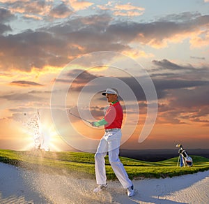 Man playing golf against colorful sunset