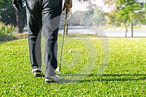 Man playing golf on green