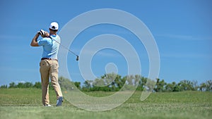 Man playing golf, rejoicing successful short distance shot and gesturing yes