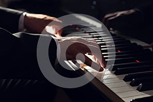 Man playing grand piano, closeup. Talented musician