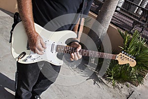 Man Playing Guitar On Boardwalk