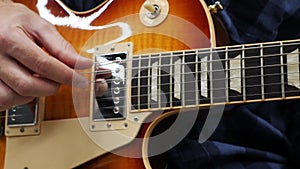 Man playing on guitar close up. Guitarist performing lyric song and solo on electric guitar. Professional guitar playing. Man lear