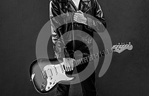 Man playing guitar close up. Hands of a musician playing the electric guitar. Electric guitar, guitarist, musician rock