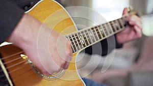 Man playing guitar at home