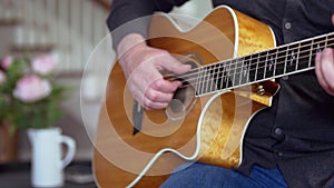 Man playing guitar at home