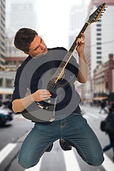 Man playing guitar in knees