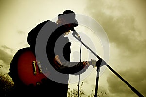 Man playing guitar outdoors