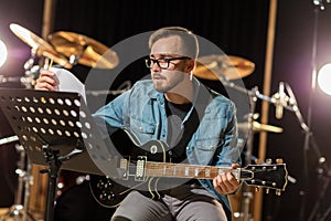 Man playing guitar at studio rehearsal