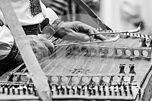 Man playing on gusli instrument. Gusli is an ancient traditional russian musical instrument. Gusli folk musical instrument in men