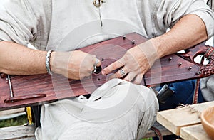 Man is playing the harp. hands closeup