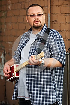 Man playing his cigar box guitar